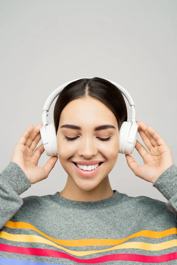 A young woman enjoying the best skullcandy headphone with her eyes closed.