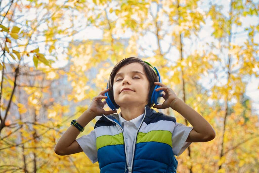 a boy wearing a skullcandy on ear headphone with blue color